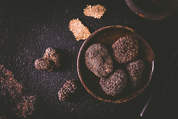 Image showing Black truffle in bowl on dark background