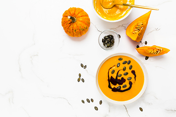 Image showing Homemade pumpkin soup with pumpkin oil and seeds