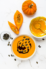 Image showing Homemade pumpkin soup with pumpkin oil and seeds