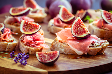 Image showing Small open sandwiches with ciabatta, proscuitto and fresh figs