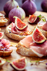 Image showing Small open sandwiches with ciabatta, proscuitto and fresh figs