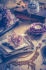 Image showing Memories - old family photo album with necklace, old books and dried flowers