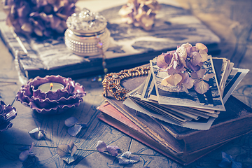 Image showing Memories - old family photo album with necklace, old books and dried flowers