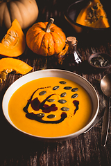 Image showing Homemade pumpkin soup with pumpkin oil and seeds