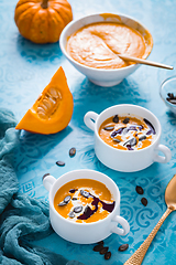 Image showing Homemade pumpkin soup with coconut milk, pumpkin oil and seeds