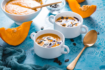 Image showing Homemade pumpkin soup with coconut milk, pumpkin oil and seeds