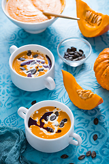 Image showing Homemade pumpkin soup with coconut milk, pumpkin oil and seeds