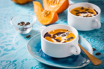 Image showing Homemade pumpkin soup with coconut milk, pumpkin oil and seeds