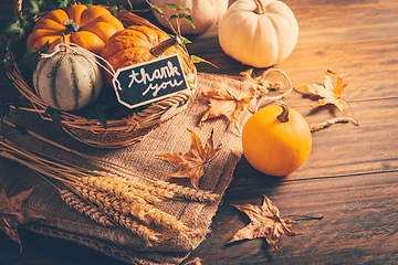 Image showing Thanksgiving - still life with pumpkins, ears and autumn leaves on wooden background