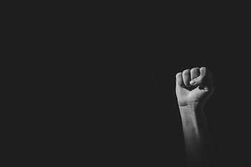 Image showing Fist pose hand with light and shadow, black an white, isolated on black