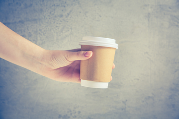Image showing Hand holding disposable coffee cup