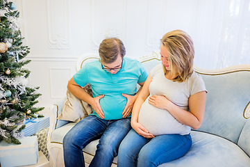 Image showing Family portrait near christmas tree. Pregnant woman