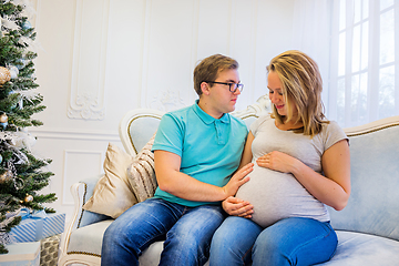 Image showing Family portrait near christmas tree. Pregnant woman