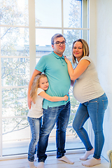 Image showing Beautiful pregnant woman, girl and man near the window