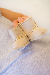 Image showing Pregnant woman holding baby booties. Macro shot