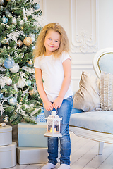 Image showing Cute girl in casual clothes and with an old lantern on her hands