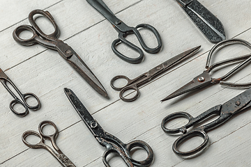 Image showing Vintage steel scissors on wooden table background