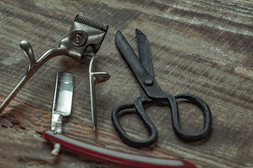 Image showing Vintage steel scissors on wooden table background