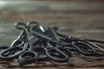 Image showing Vintage steel scissors on wooden table background