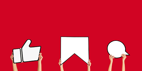 Image showing Hands holding the signs of social media on red studio background, flyer