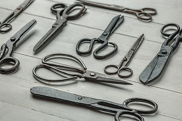 Image showing Vintage steel scissors on wooden table background