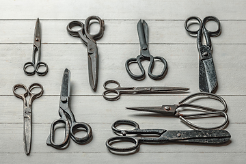 Image showing Vintage steel scissors on wooden table background