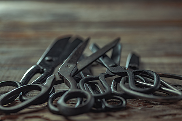 Image showing Vintage steel scissors on wooden table background