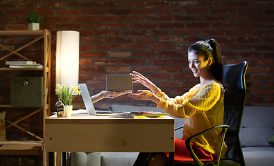 Image showing Young Caucasian woman talking with friend online through laptop.