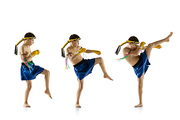 Image showing Little boy exercising thai boxing on white background. Fighter practicing, training in martial arts in action, motion. Evolution of movement, catching moment.