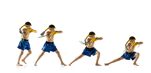 Image showing Little boy exercising thai boxing on white background. Fighter practicing, training in martial arts in action, motion. Evolution of movement, catching moment.