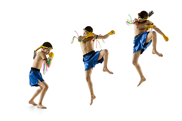 Image showing Little boy exercising thai boxing on white background. Fighter practicing, training in martial arts in action, motion. Evolution of movement, catching moment.