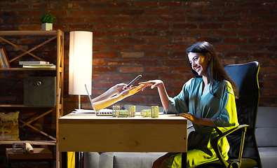 Image showing Young Caucasian woman talking with friend online through laptop.