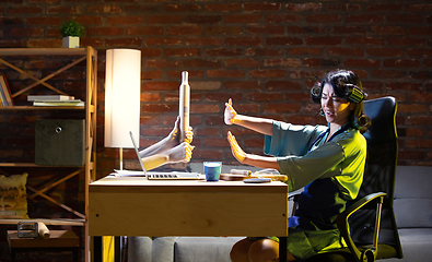 Image showing Young Caucasian woman during online cooking lesson through laptop.