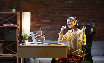 Image showing Young Caucasian woman talking with friend online through laptop.