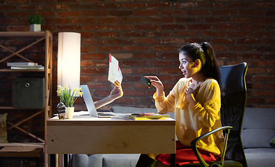 Image showing Young Caucasian woman using online banking through laptop.