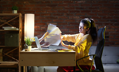 Image showing Young Caucasian woman talking with friend online through laptop.