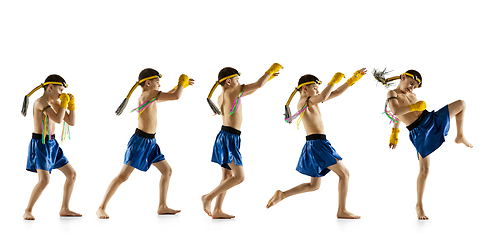 Image showing Little boy exercising thai boxing on white background. Fighter practicing, training in martial arts in action, motion. Evolution of movement, catching moment.