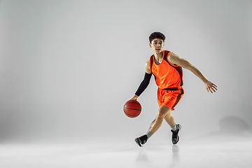 Image showing Young basketball player training isolated on white studio background