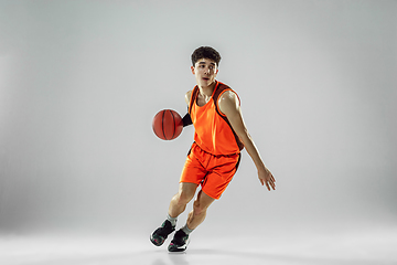 Image showing Young basketball player training isolated on white studio background