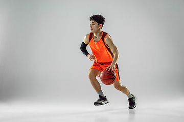 Image showing Young basketball player training isolated on white studio background