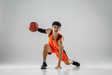 Image showing Young basketball player training isolated on white studio background