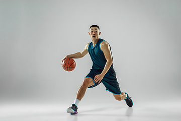 Image showing Young basketball player training isolated on white studio background