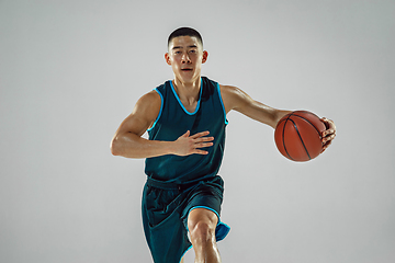 Image showing Young basketball player training isolated on white studio background