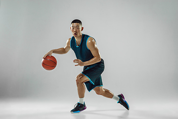 Image showing Young basketball player training isolated on white studio background