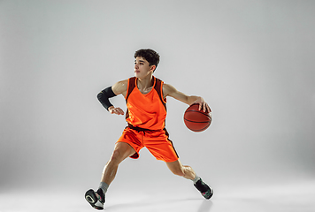 Image showing Young basketball player training isolated on white studio background