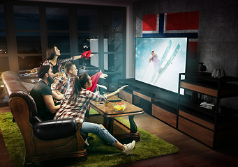 Image showing Group of friends watching TV, fans of skiing in Norway, sport games