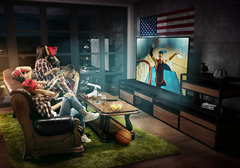 Image showing Group of friends watching TV, basketball match in America, sport games