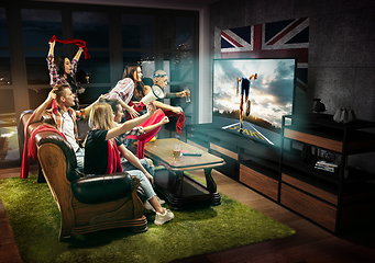 Image showing Group of friends watching TV, run competition in Great Britain, sport games
