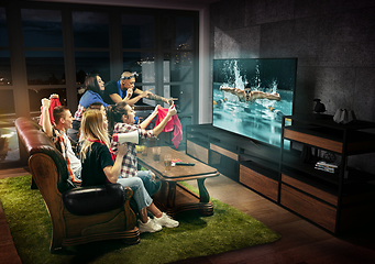 Image showing Group of friends watching TV, swimming sport games