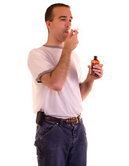 Image showing Man Swallowing Medicine